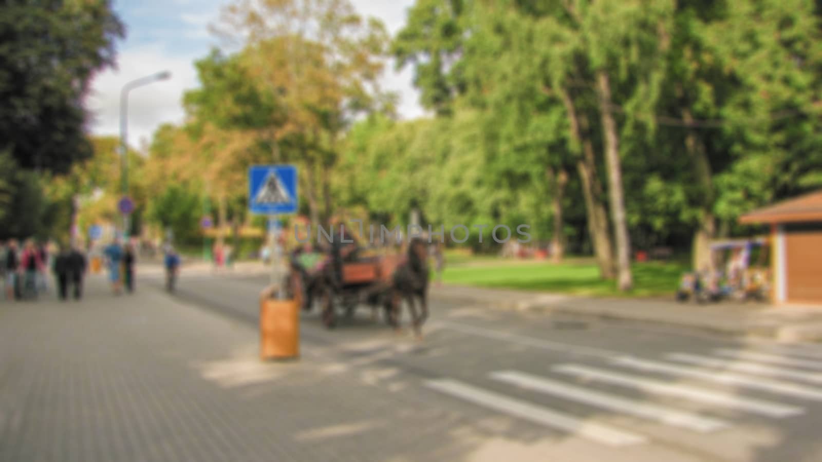 Blurred background of a city street. Urban landscape. Creative theme with blur and bokeh effect for backgrounds, posters and screensavers.