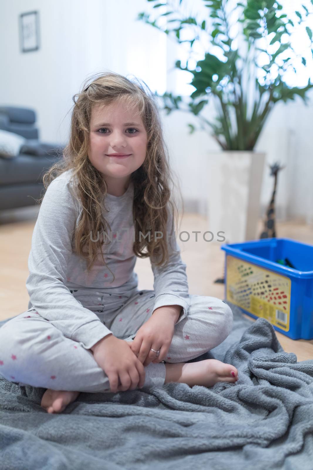 Portrait of a cute little Caucasian girl child with disheveled hair.