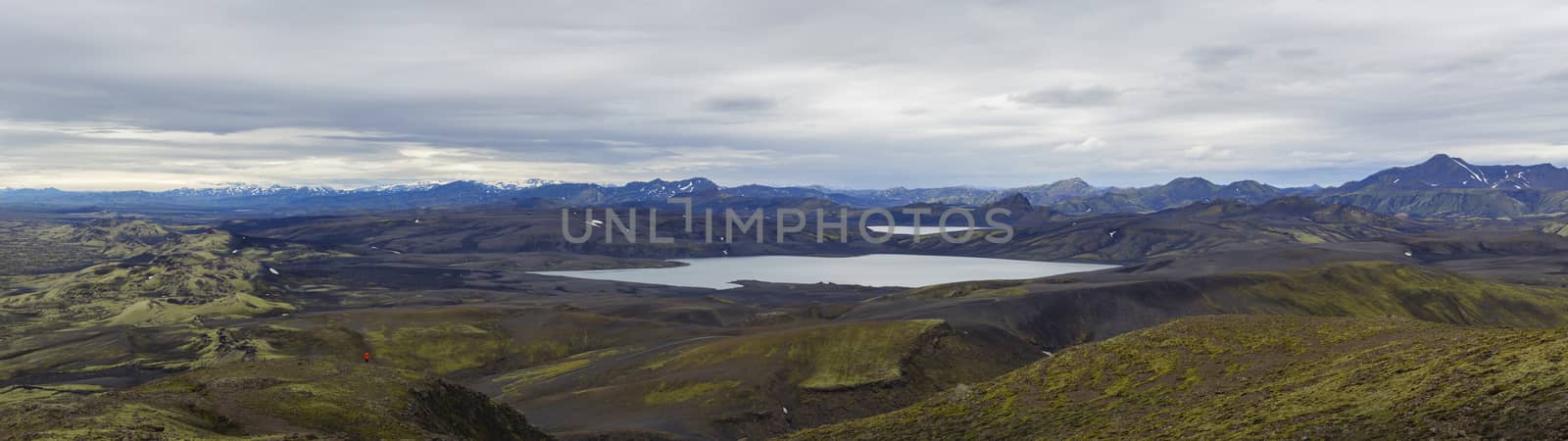 Colorful wide panorama, panoramic view on Volcanic landscape in Lakagigar, Laki Volcano crater chain with green lichens, moss and lakes Kambavatn and Lambavatn, Iceland, moody sky background