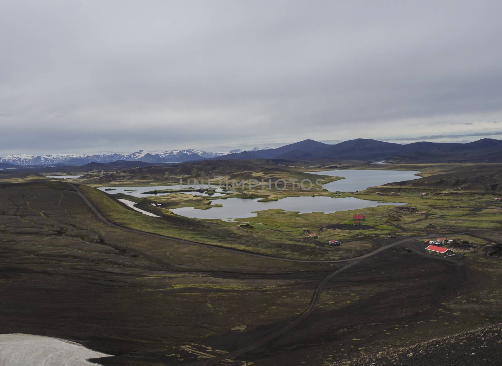 veidivotn fishing hut and cabin, landscape with Colorful crater lake and volcanic snow covered mountains in Veidivotn lakes, popular fishing area for local, central Iceland highlands in the middle of black lava desert by Henkeova