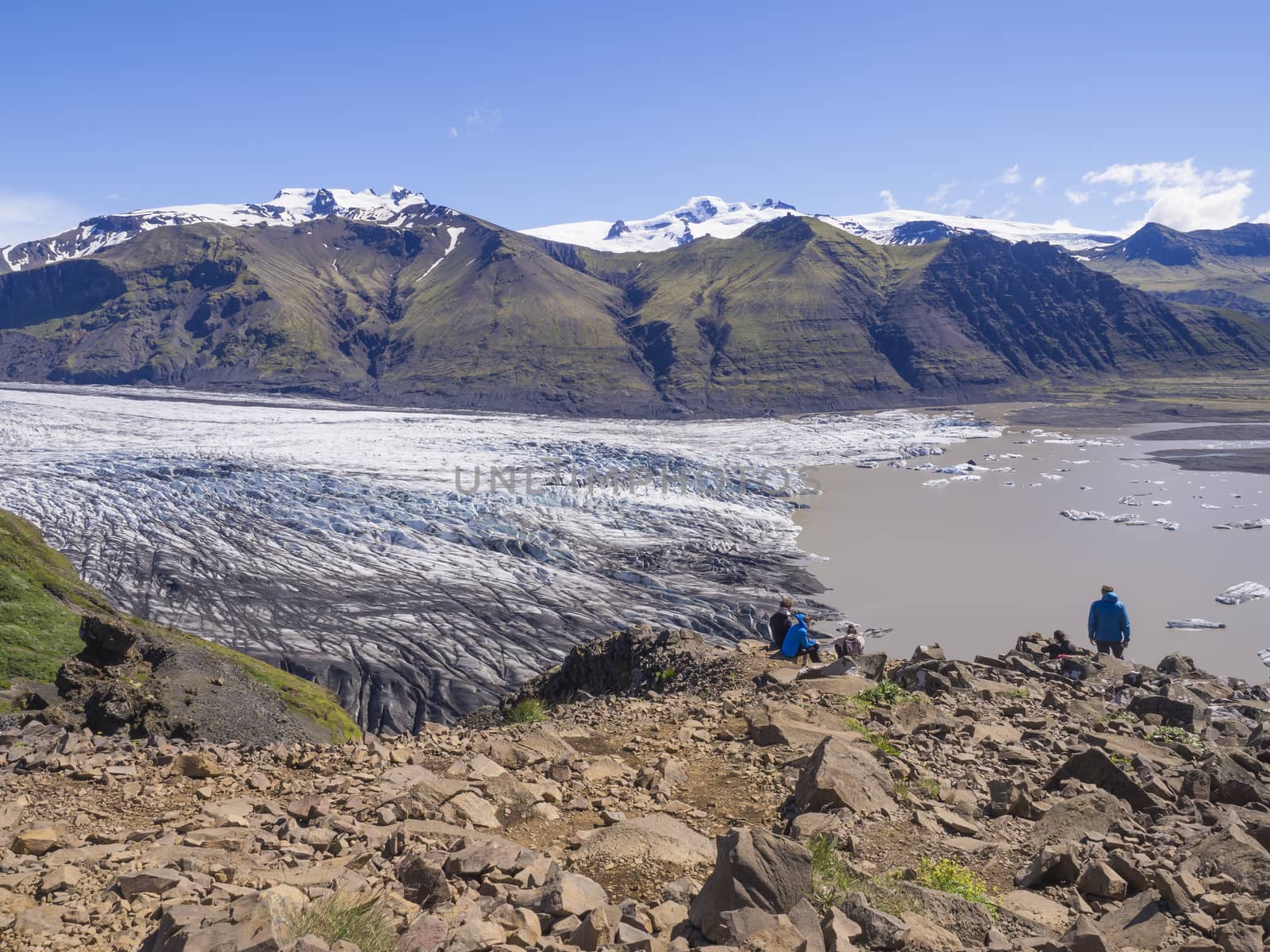 View on glacier lagoon with icebergs and tongue of Skaftafellsjokull, Vatnajokull spur, valley Morsardalur river and colorful rhyolit mountains in Skaftafell national park, Iceland