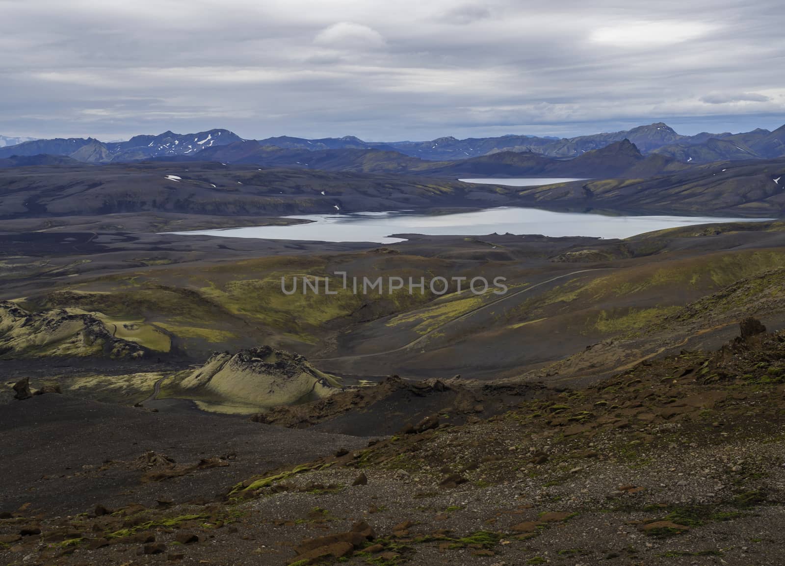 Colorful wide panorama, panoramic view on Volcanic landscape in Lakagigar, Laki Volcano crater chain with green lichens, moss and lakes Kambavatn and Lambavatn, Iceland, moody sky background