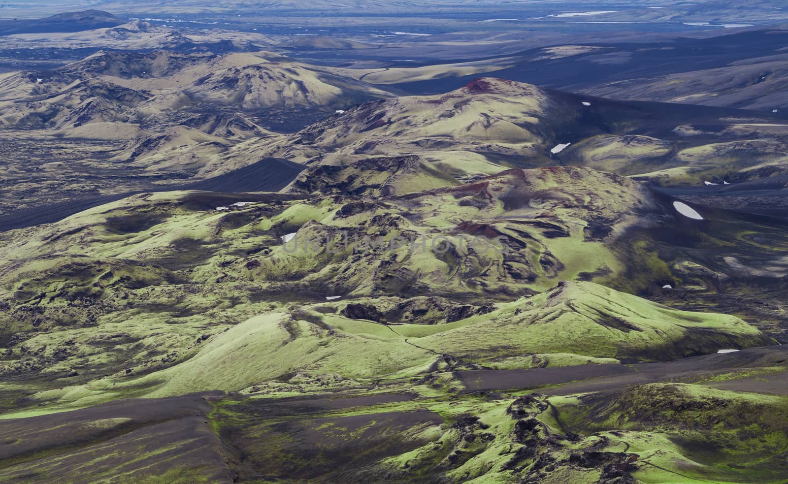 View on colorful Volcanic landscape in Lakagigar, Laki Volcano crater chain with hills covered green and yellow lichens, Iceland
