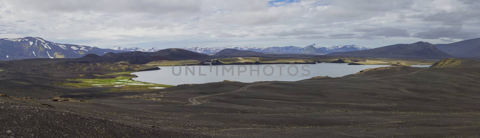Colorful wide panorama, panoramic view on landscape with volcanic snow covered mountains and crater lakes and dirty mountain roads in Veidivotn area, central Iceland highlands in the middle of black lava desert by Henkeova