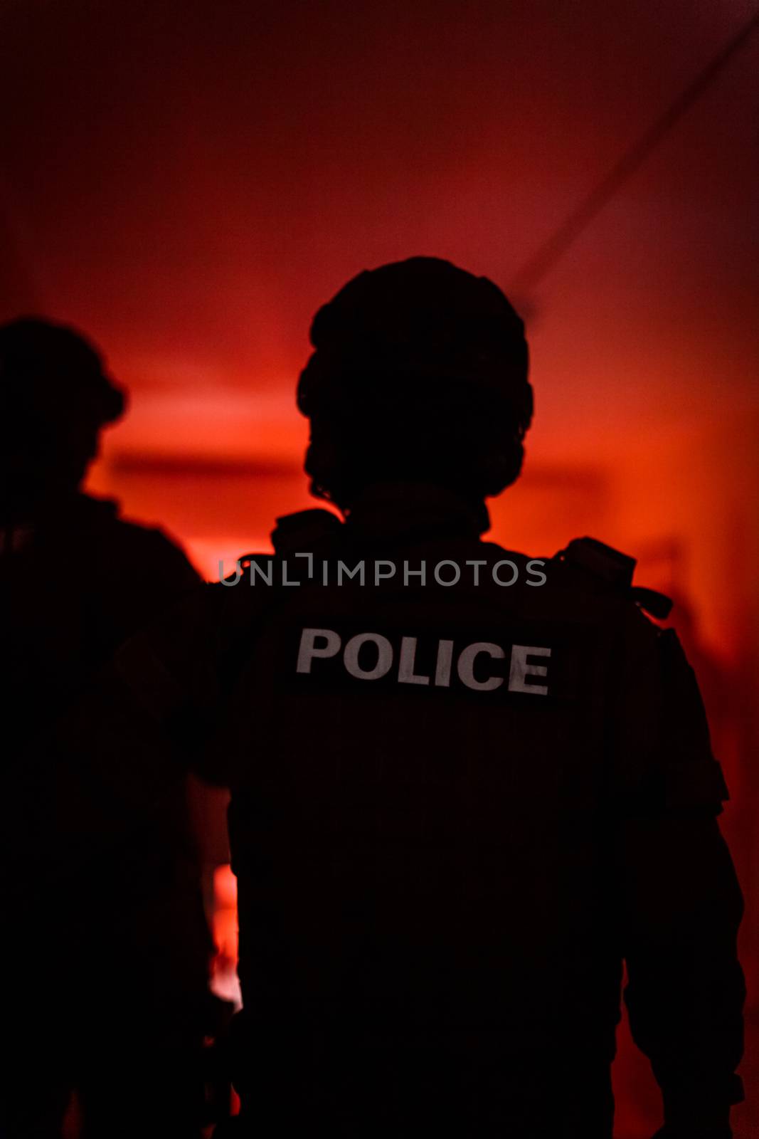 Silhouette of a police officer. Police commando in action, arresting the perpetrator in the building by Edophoto
