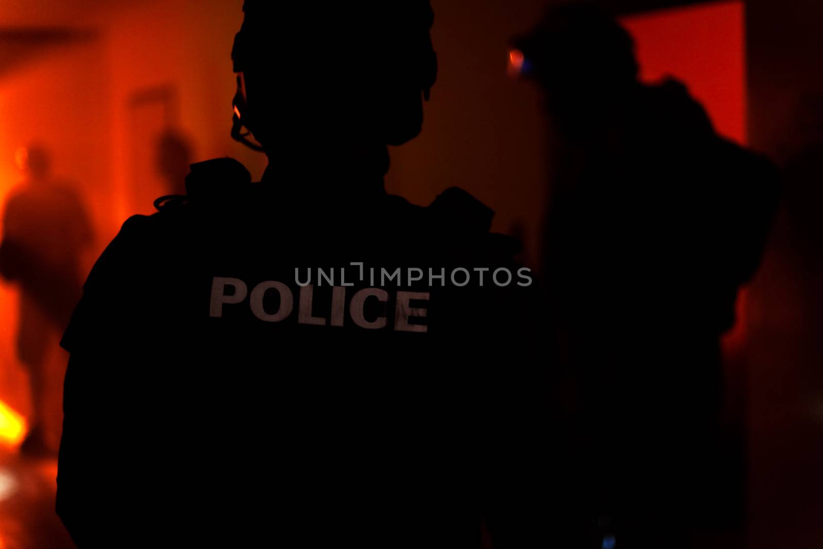 Silhouette of a police officer. Police commando in action, arresting the perpetrator in the building.