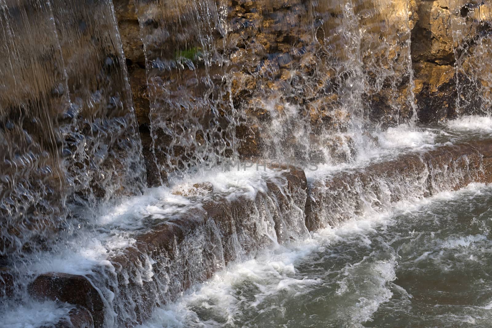 The water falling from above on stones on a decline of day