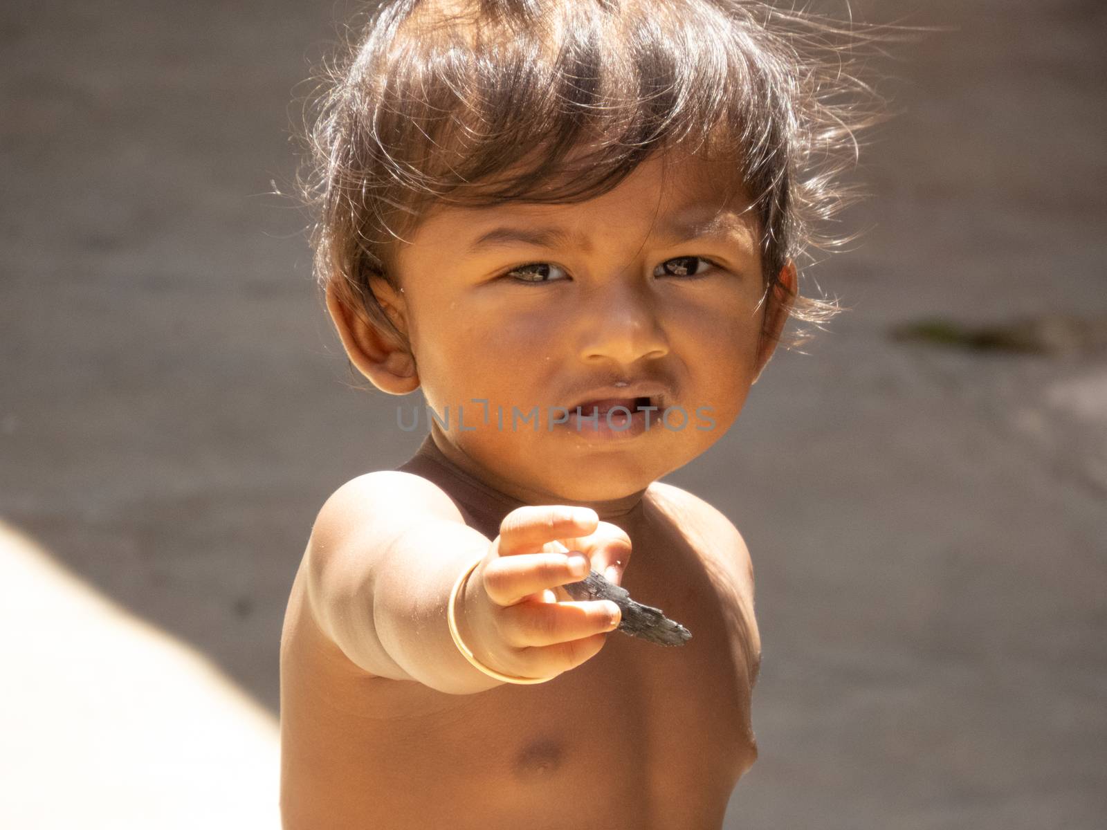 A child showing his hand to the camera by 9500102400