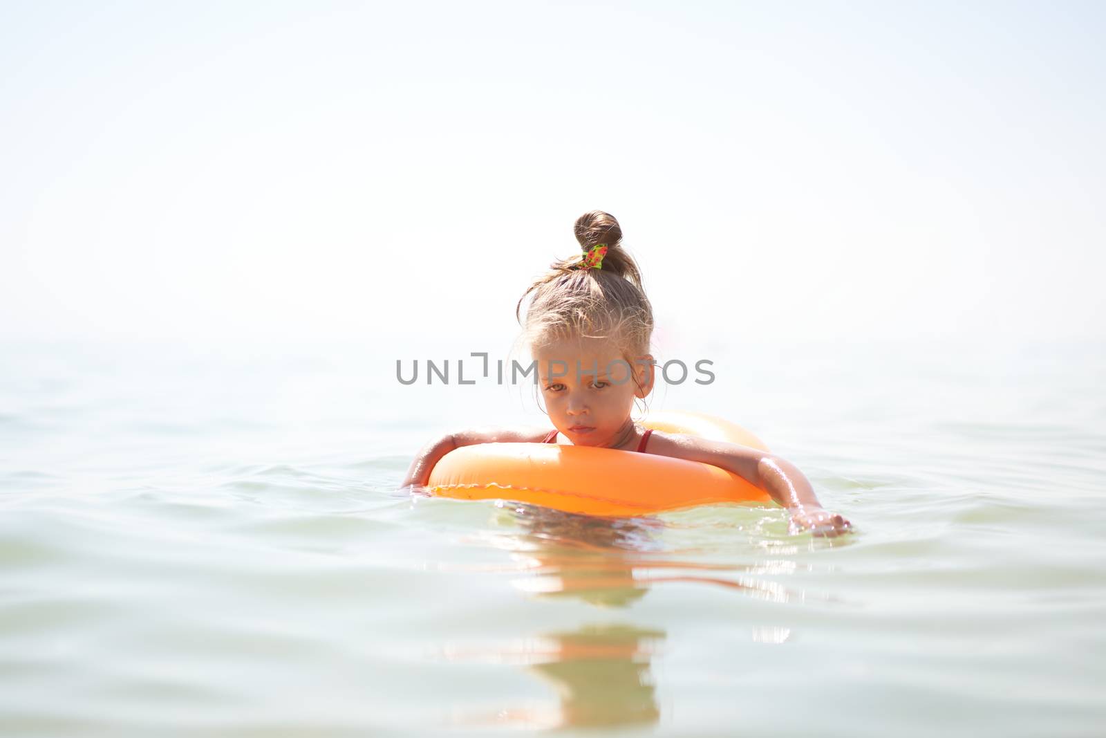Child swims sea inflatable ring. danger of drowning Safety equipment, Child Life buoy Little Caucasian girl have fun in sea water Summer vacation active leisure. Lifestyle