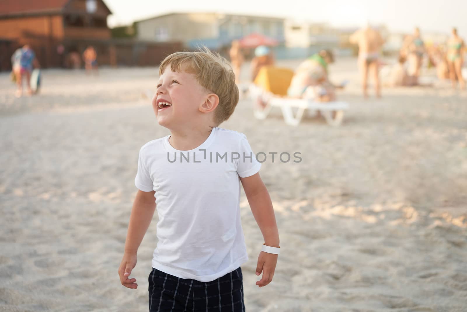 Caucasian boy standing beach. Childhood summertime. Family vacation with one child.
