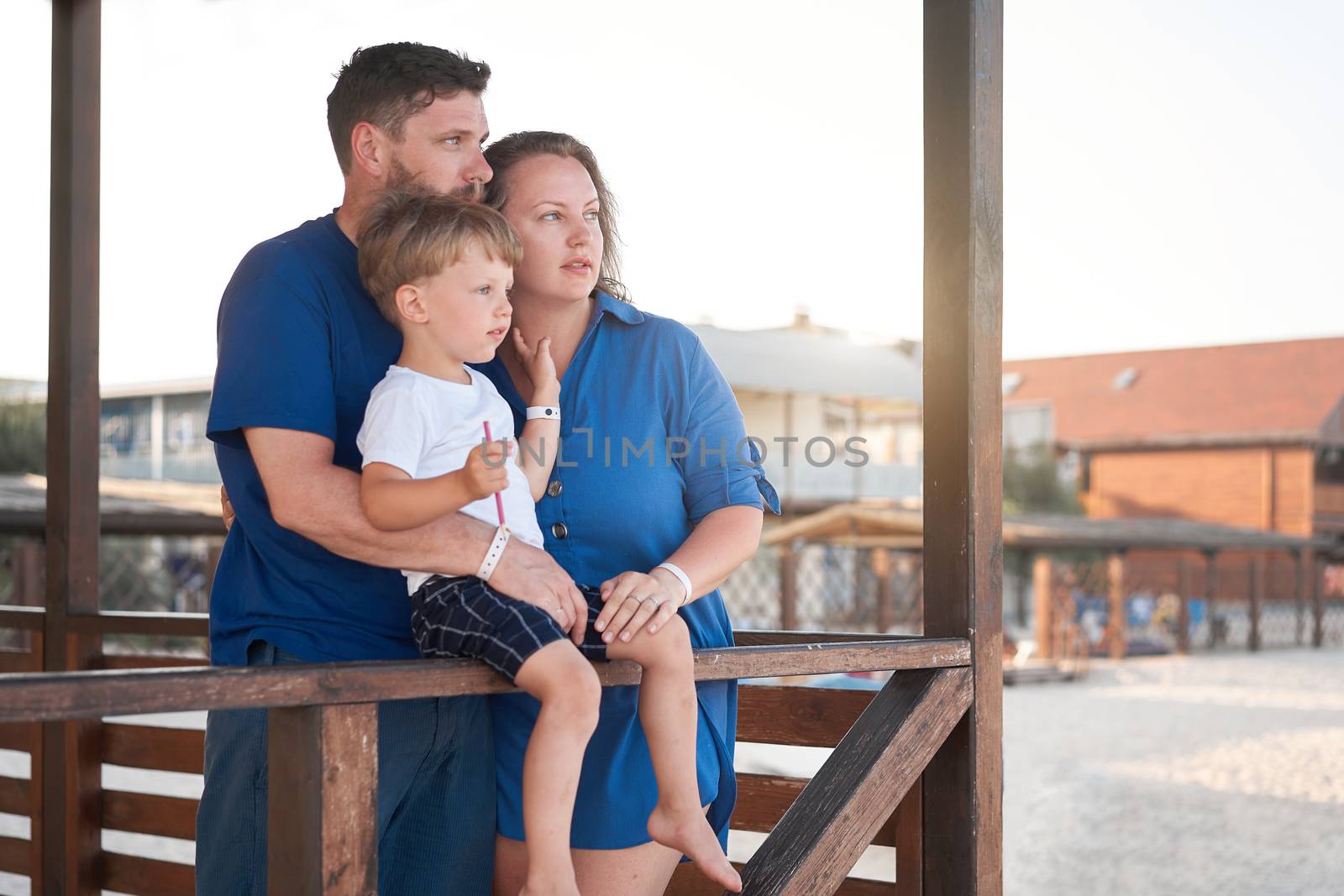 Mother father kid spending time together family vacation Parent dad mom walking with son enjoying sea beach Happy family concept. Blue color clothes. Family with one child