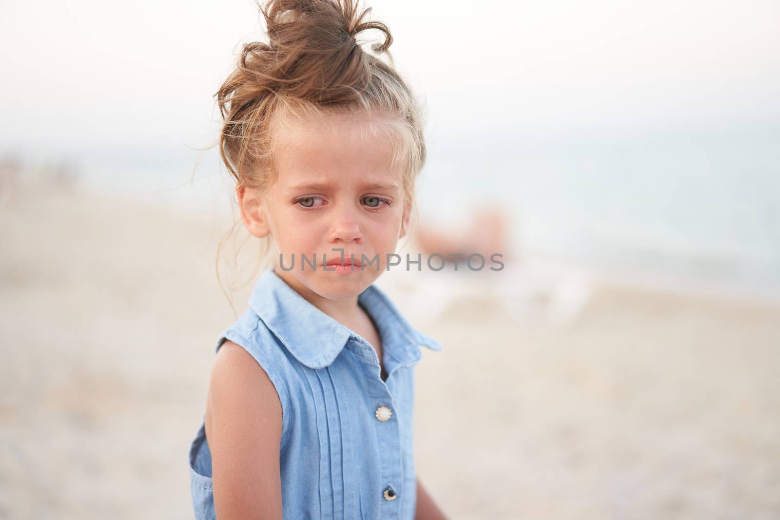 Little girl crying beach. Sad Summer Vacation. the child is lost by andreonegin