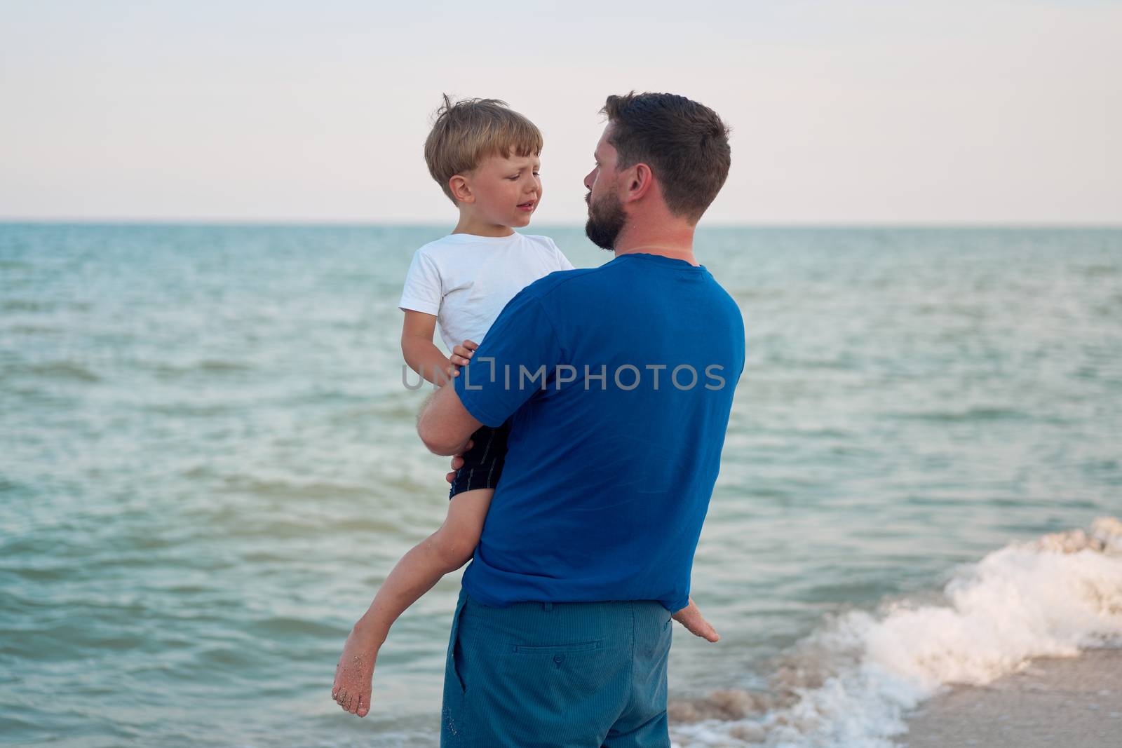 Father son spending time together sea vacation Young dad child little boy walking beach by andreonegin
