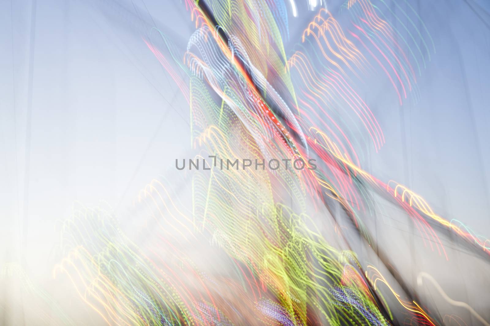Amusement park blurred effect. Abstract illuminated background by andreonegin