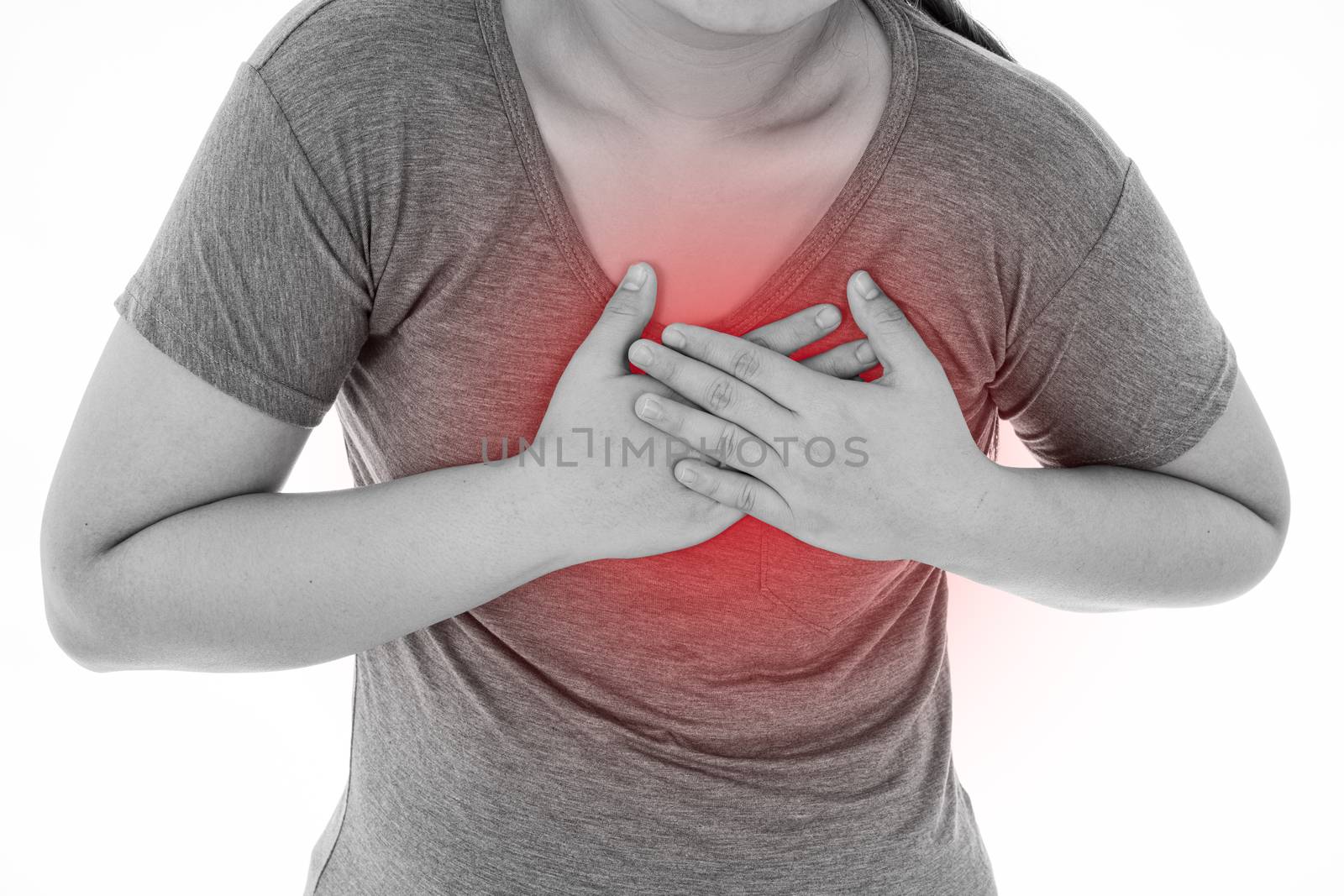 Black and white shot of woman feeling exhausted and suffering from heart pain and injury on isolated white background with red spot. Health care and medical concept.