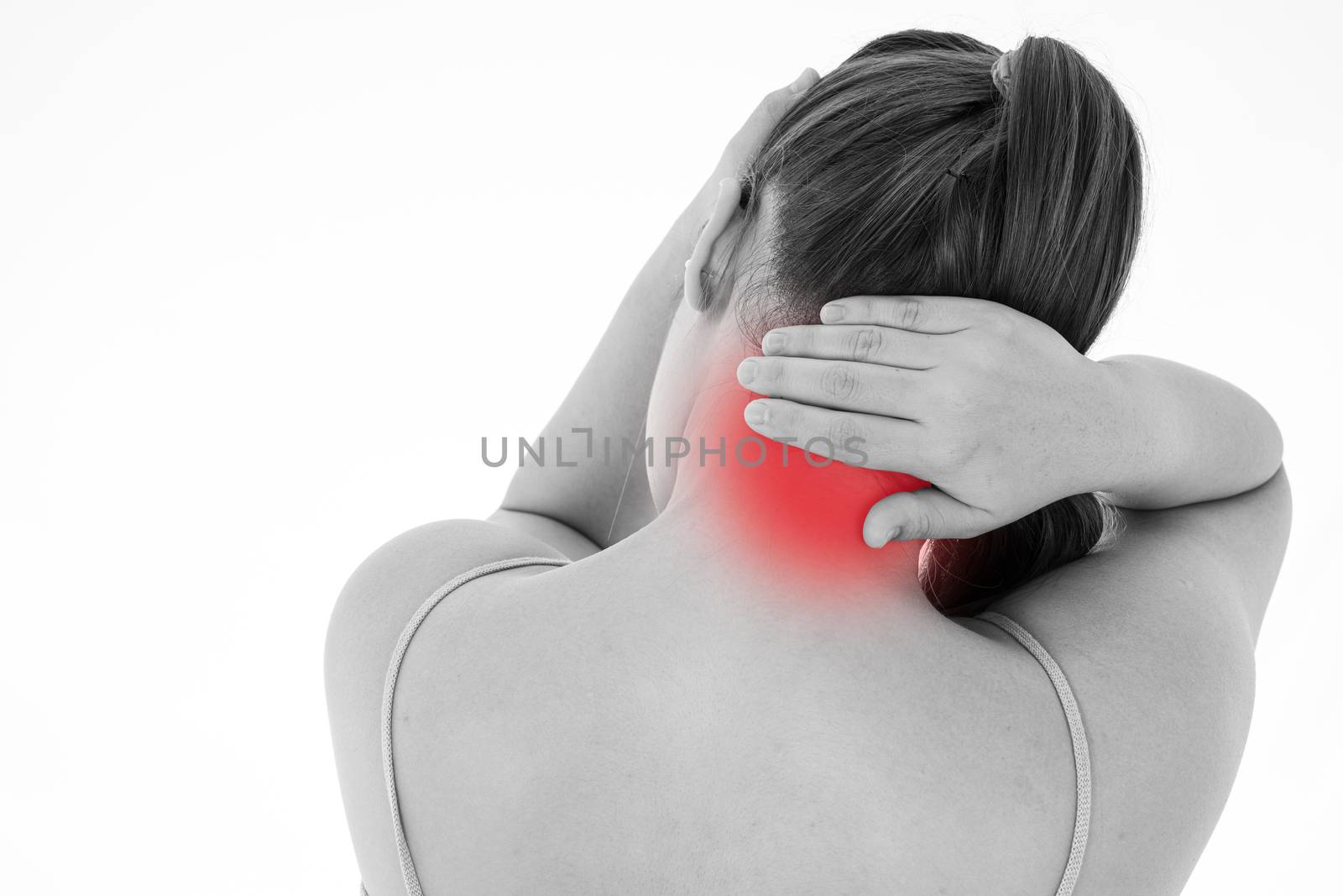 Black and white shot of woman feeling exhausted and suffering from neck and head pain and injury on isolated white background with red spot. Health care and medical concept.