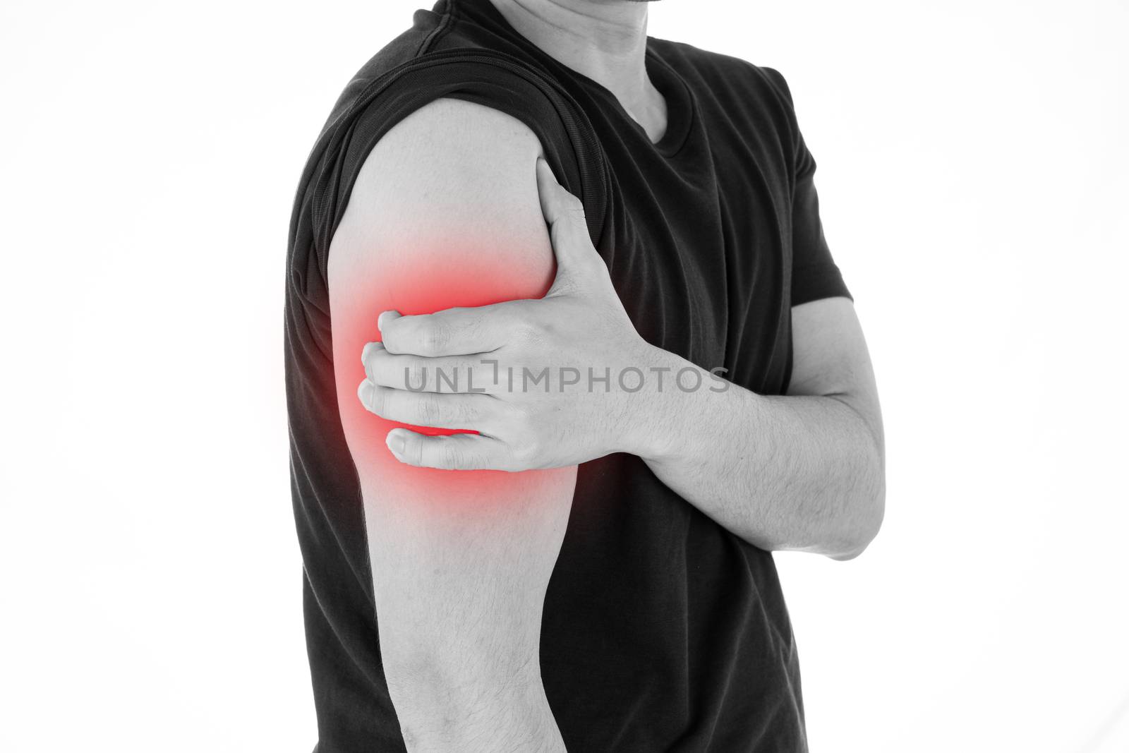 Black and white shot of man feeling exhausted and suffering from arm pain and injury on isolated white background with red spot. Health care and medical concept.
