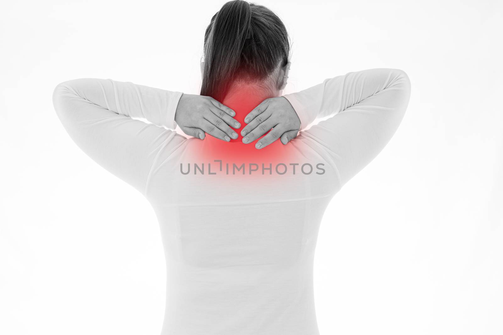 Black and white shot of woman feeling exhausted and suffering from shoulder and neck pain and injury on isolated white background with red spot. Health care and medical concept.
