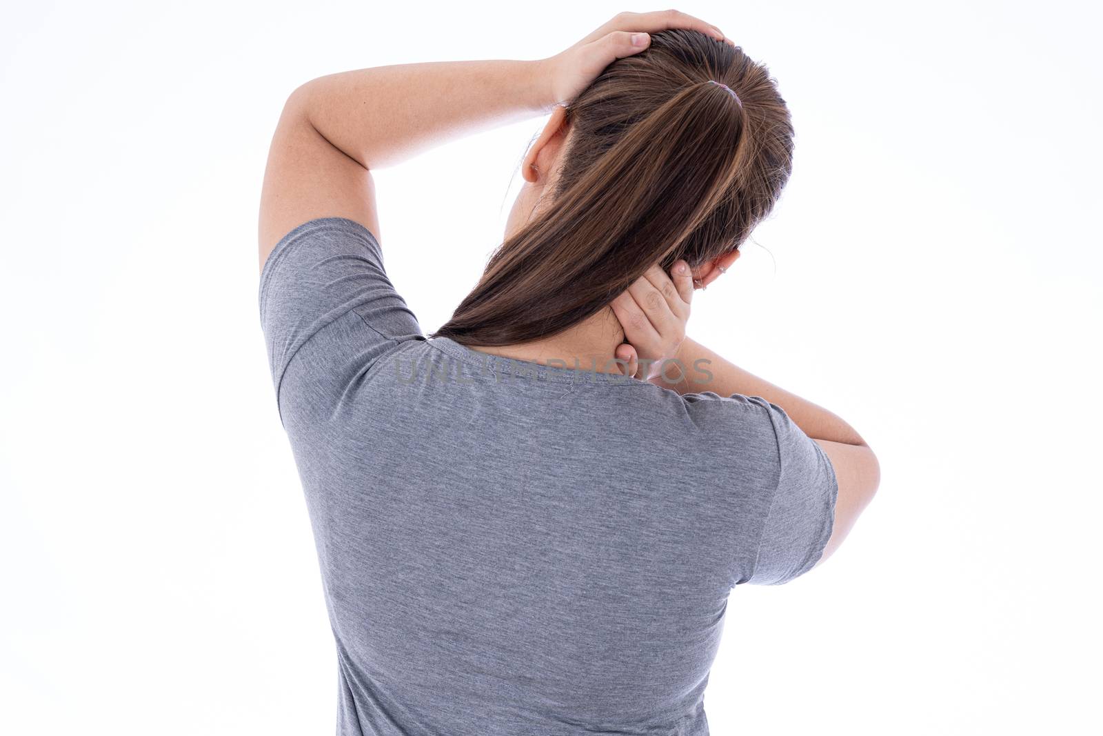 A woman feeling exhausted and suffering from neck and head pain and injury on isolated white background. Health care and medical concept.