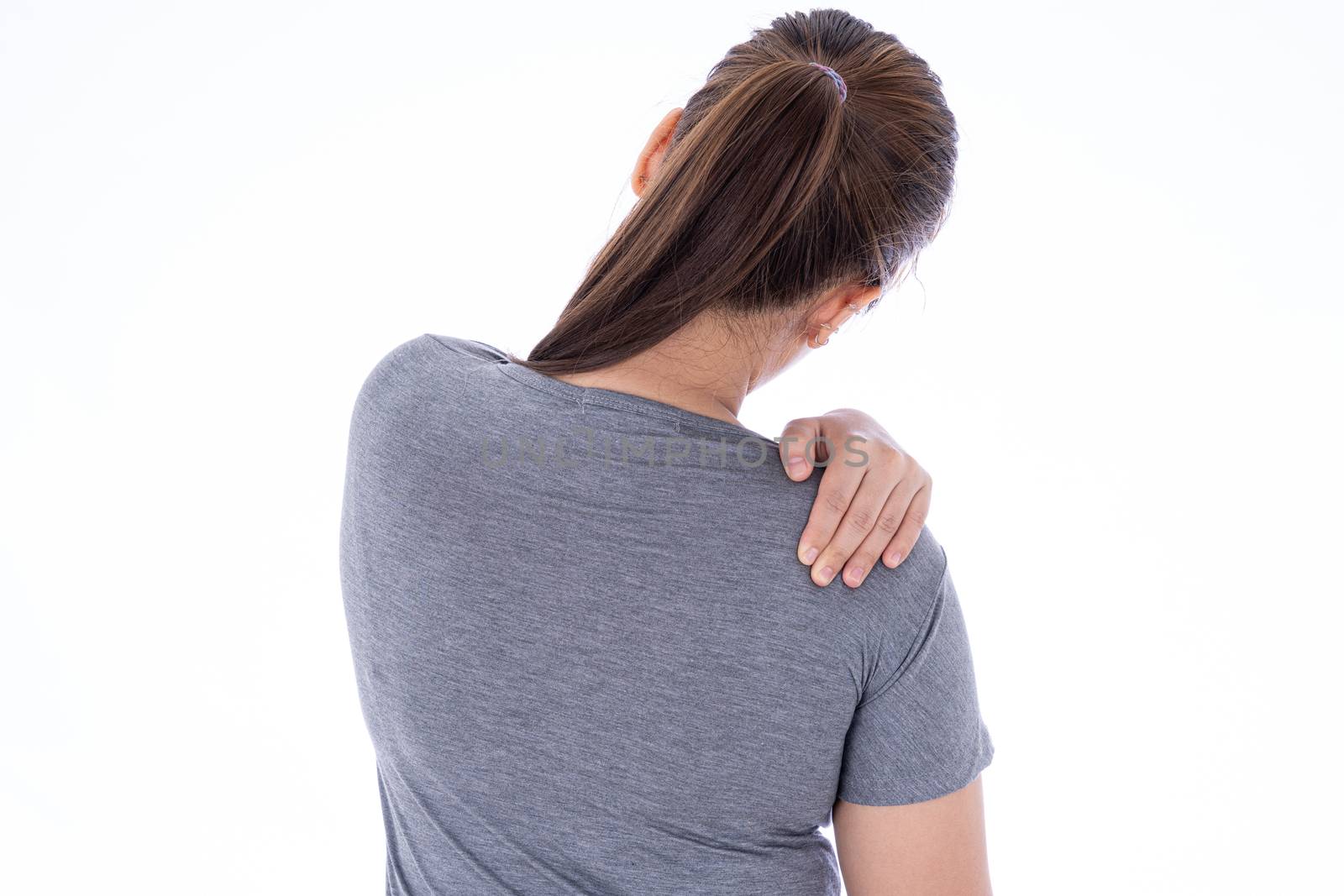 A woman feeling exhausted and suffering from shoulder and neck pain and injury on isolated white background. Health care and medical concept.
