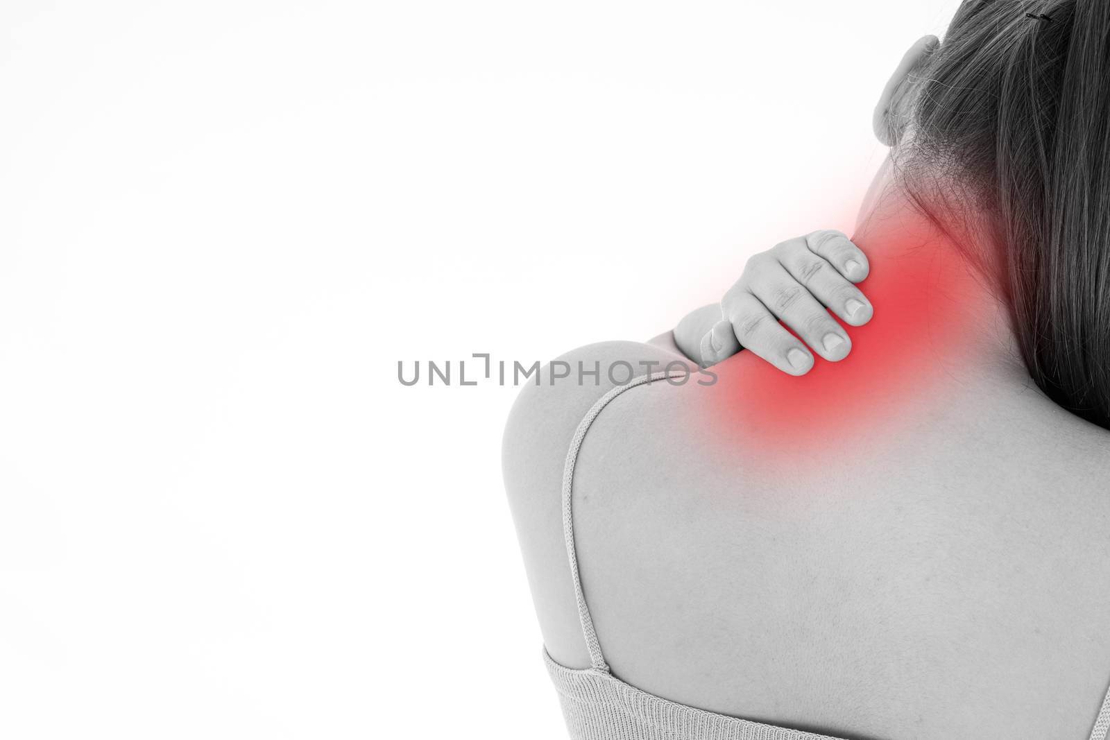 Black and white shot of woman feeling exhausted and suffering from shoulder and neck pain and injury on isolated white background with red spot. Health care and medical concept.