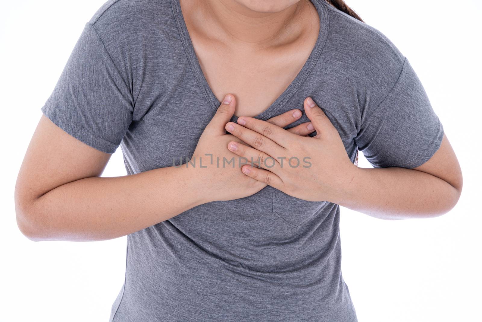 A woman feeling exhausted and suffering from heart pain and injury on isolated white background. Health care and medical concept.