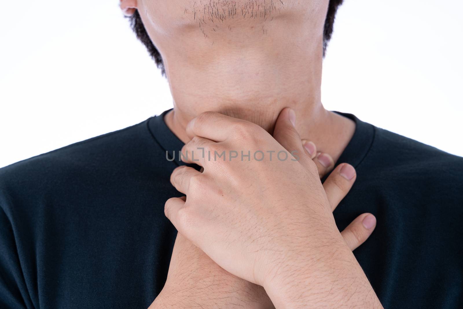 A man feeling exhausted and suffering from neck pain and injury on isolated white background. Health care and medical concept.