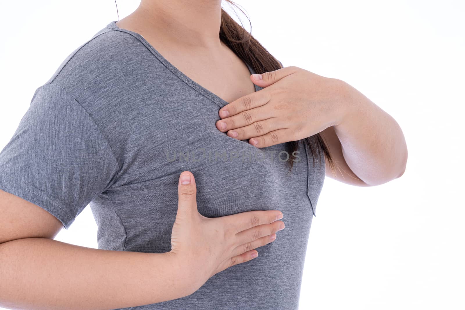 Healthcare, medicine and breast cancer awareness concept. Closeup on woman chest checking her breast on isolated white background, breast self exam.