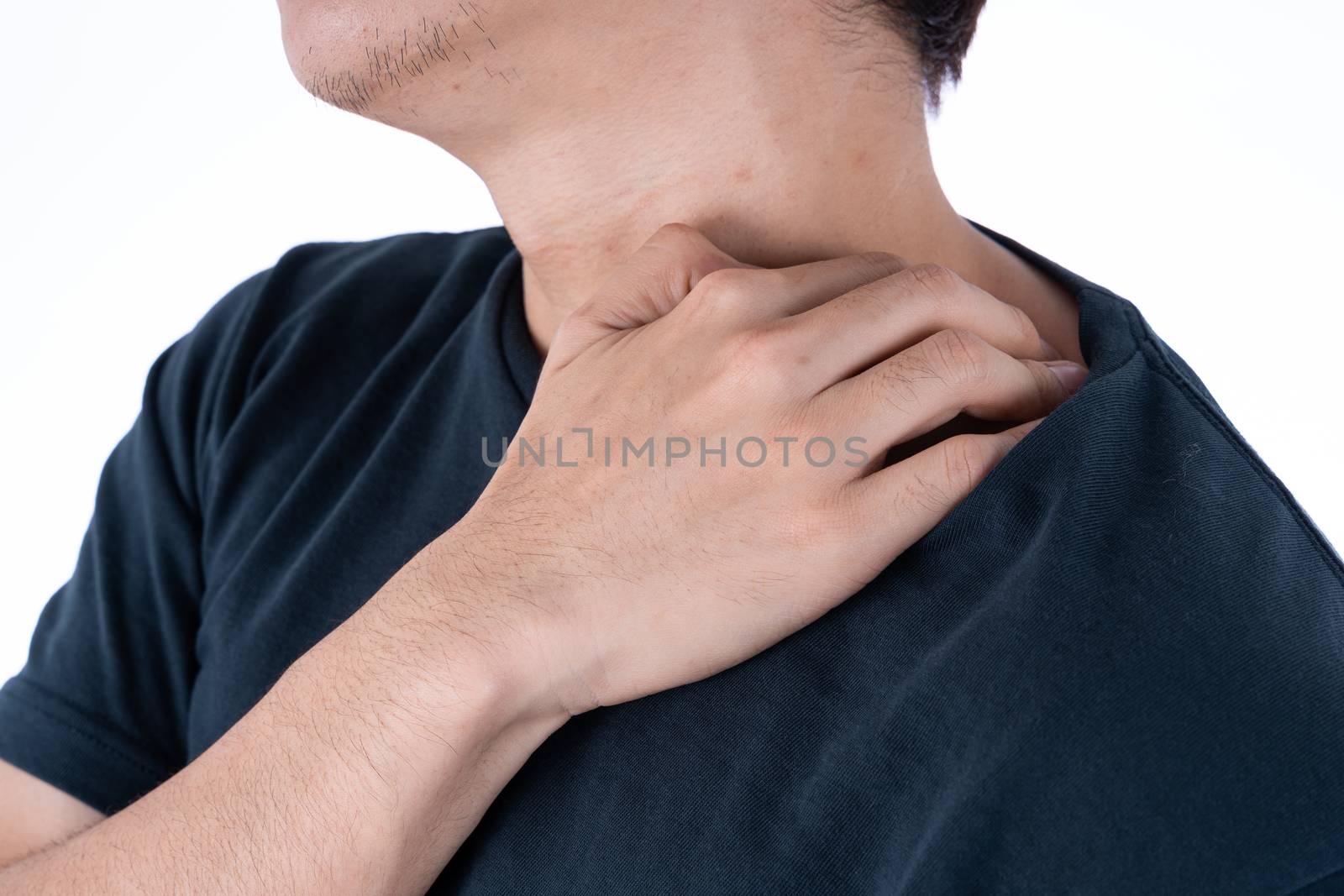 A man feeling exhausted and suffering from shoulder and neck pain and injury on isolated white background. Health care and medical concept.