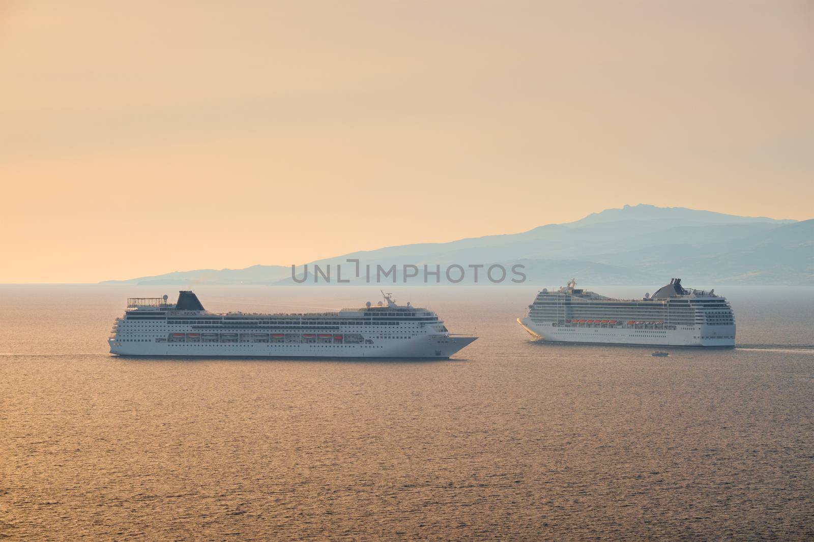 Cruise ships in Aegean sea on sunset by dimol