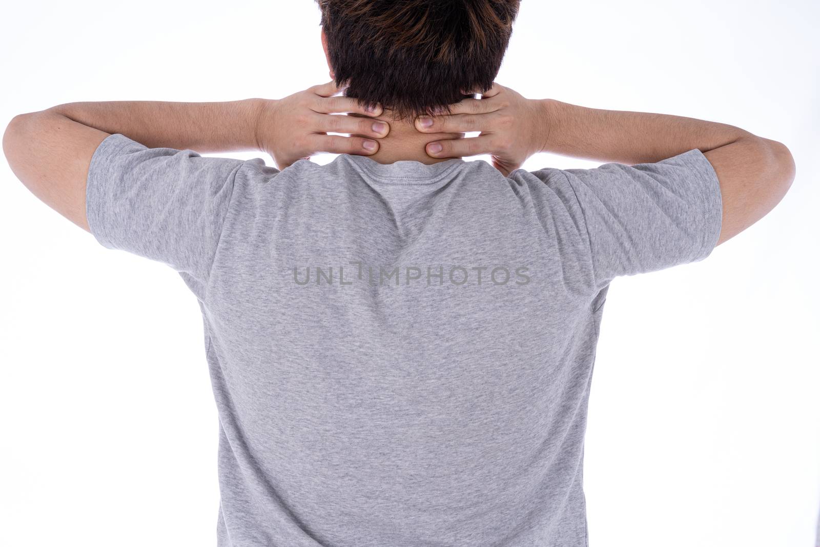 A man feeling exhausted and suffering from shoulder and neck pain and injury on isolated white background. Health care and medical concept.