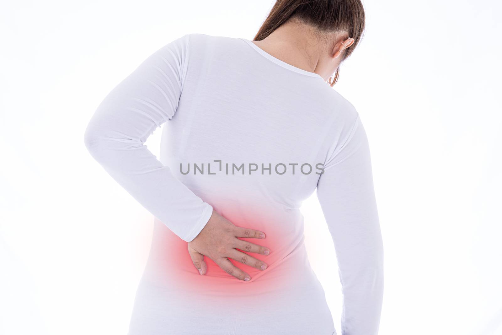 A woman feeling exhausted and suffering from waist and back pain and injury on isolated white background with red spot. Health care and medical concept.