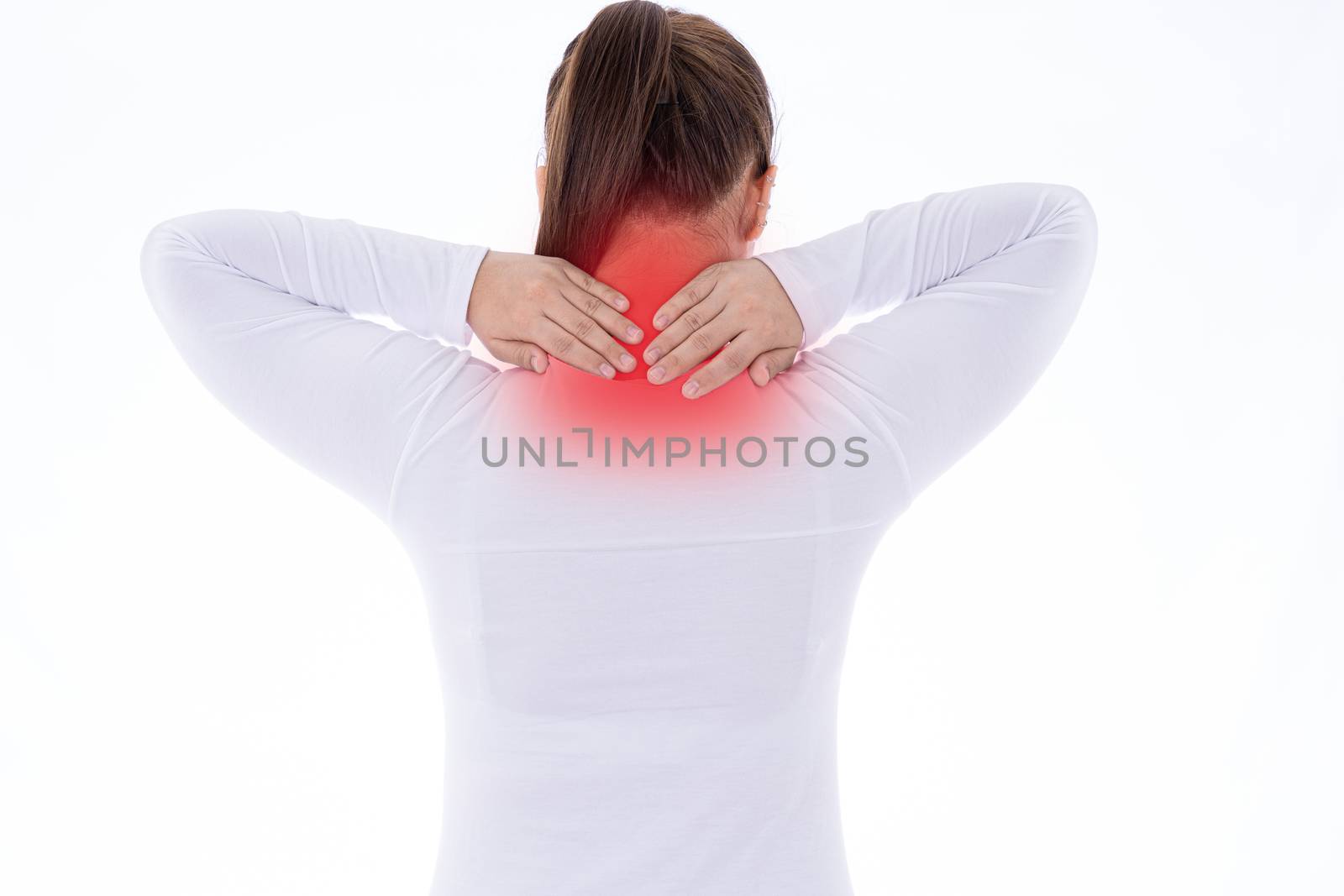 A woman feeling exhausted and suffering from shoulder and neck pain and injury on isolated white background with red spot. Health care and medical concept.