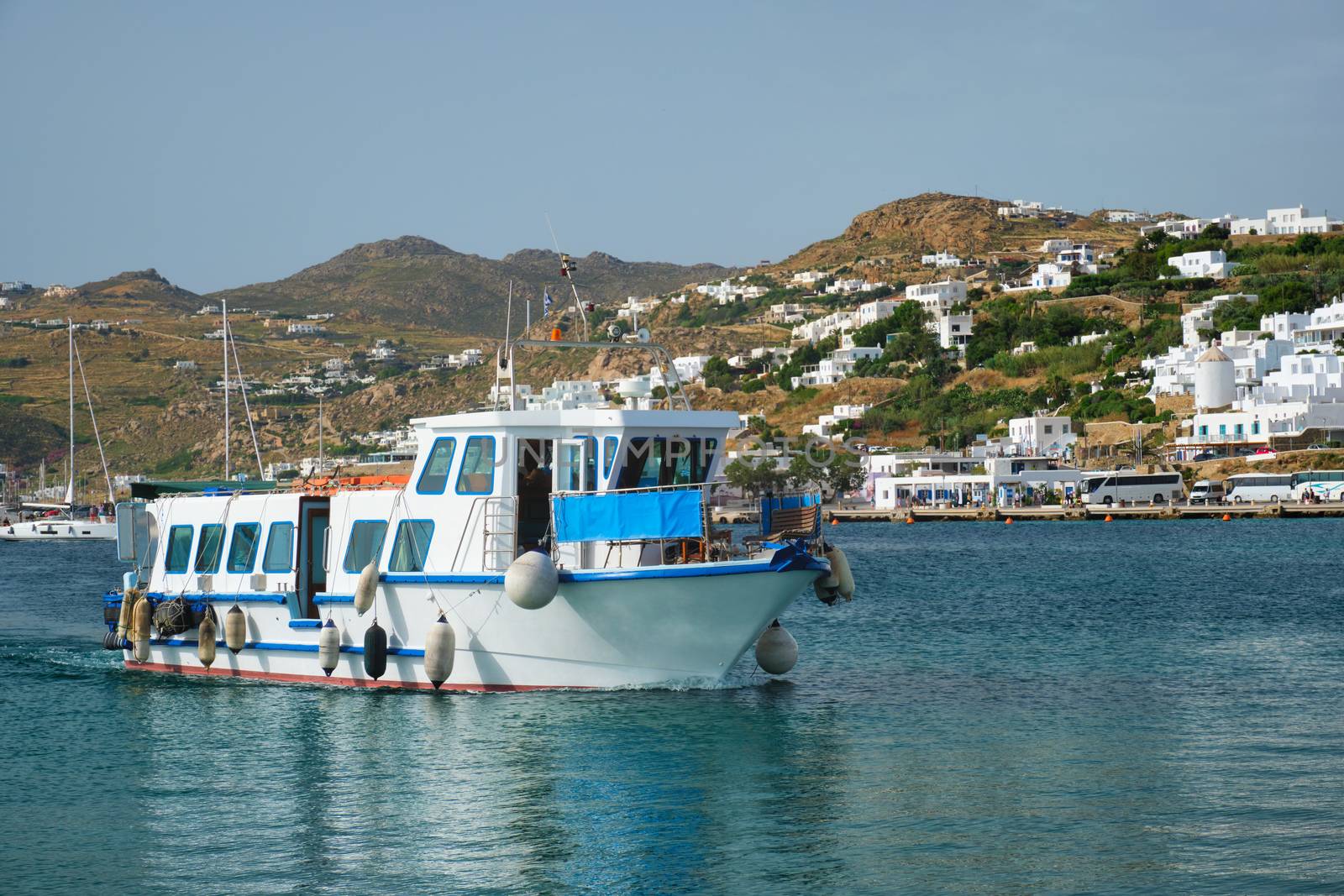 Boat in port harbor of Chora town on Mykonos island, Greece by dimol