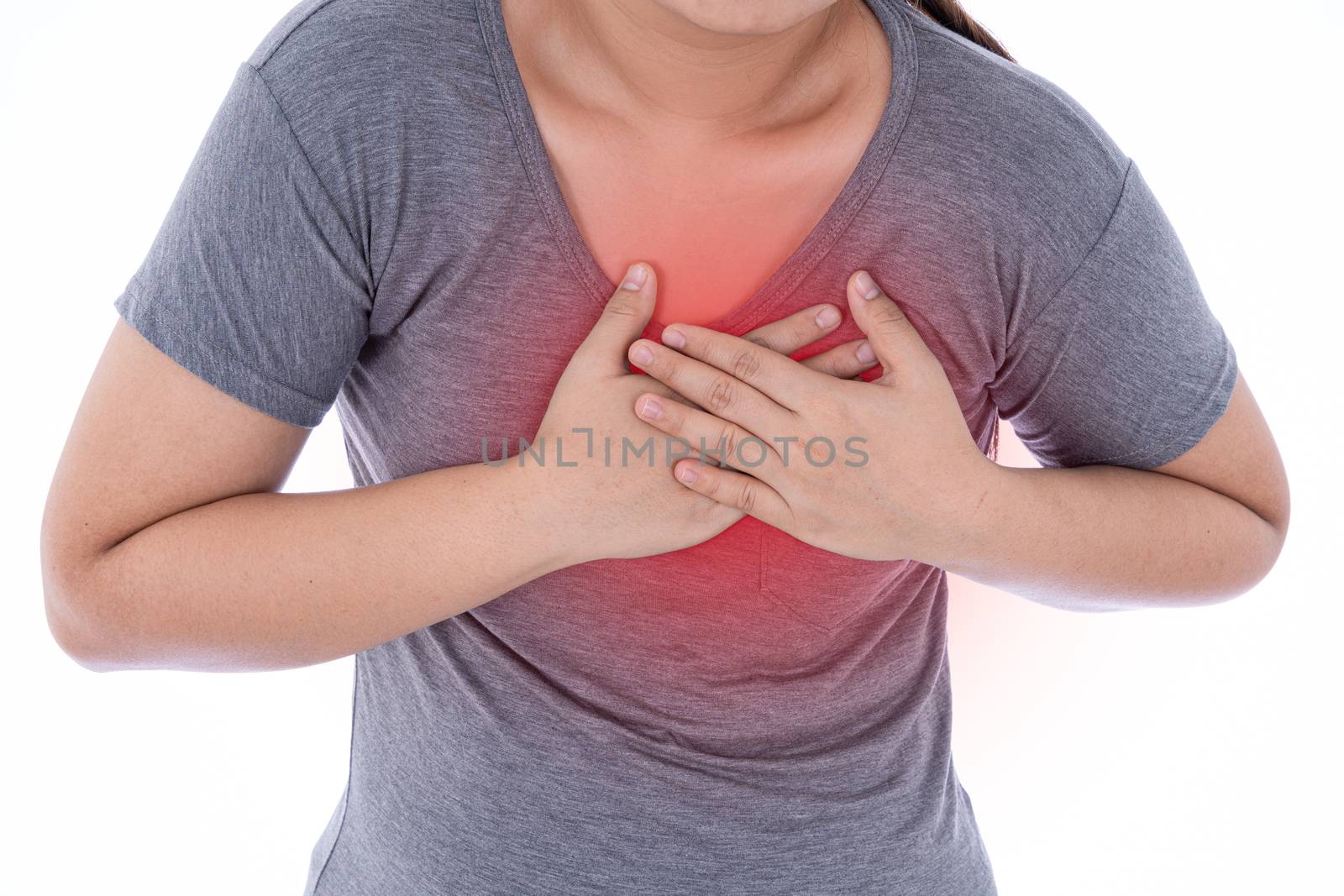 A woman feeling exhausted and suffering from heart pain and injury on isolated white background with red spot. Health care and medical concept.