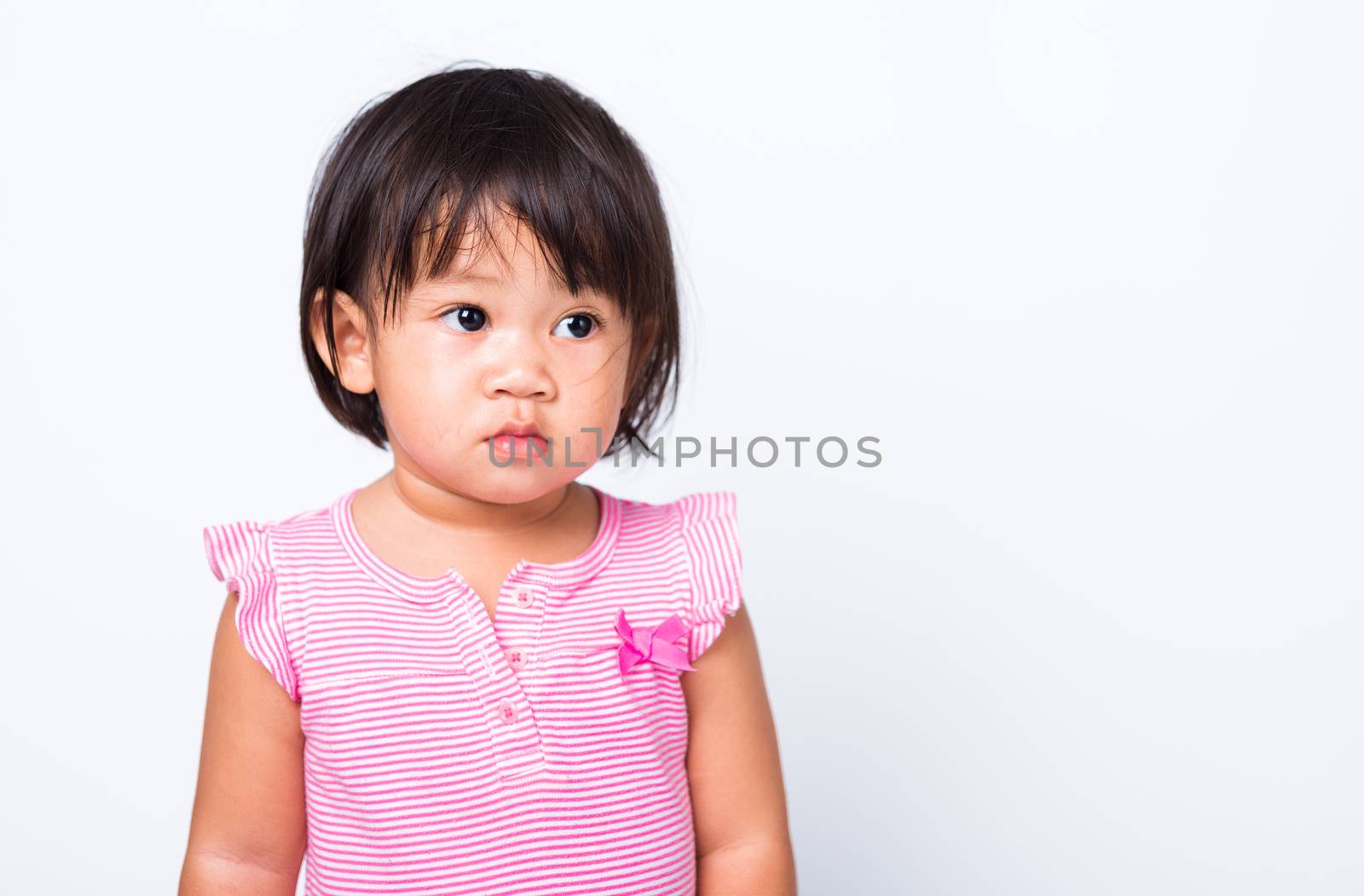 Portrait closeup face of Thai Asian little cute baby child girl, studio shot isolated on white background
