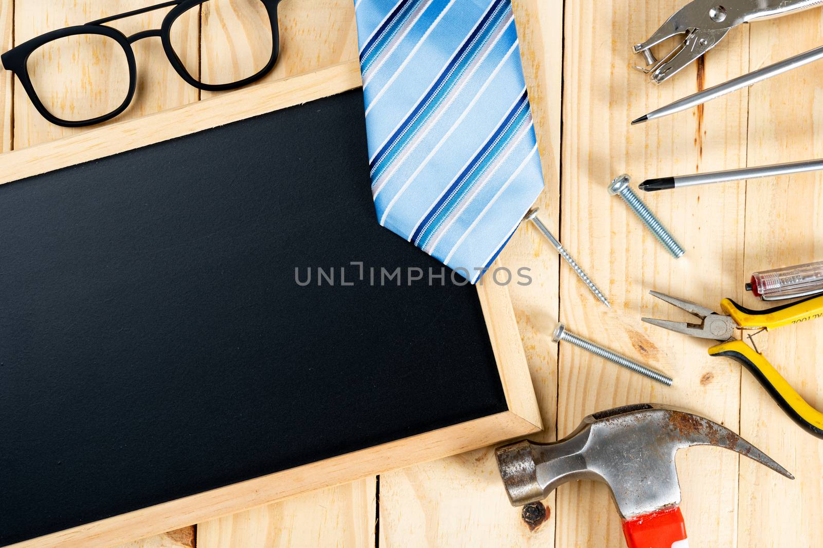 Happy Father Day background concept with tools, blackboard and tie on wooden background with copy space for text.
