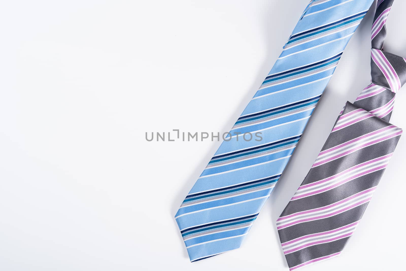 Happy Father Day background concept with blue and pink necktie on white background with copy space for text.