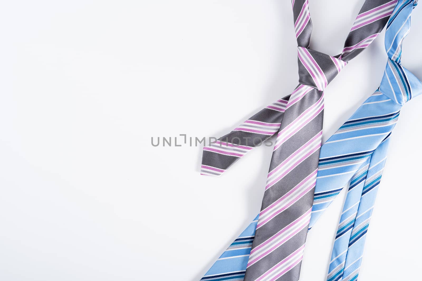 Happy Father Day background concept with blue and pink necktie on white background with copy space for text.
