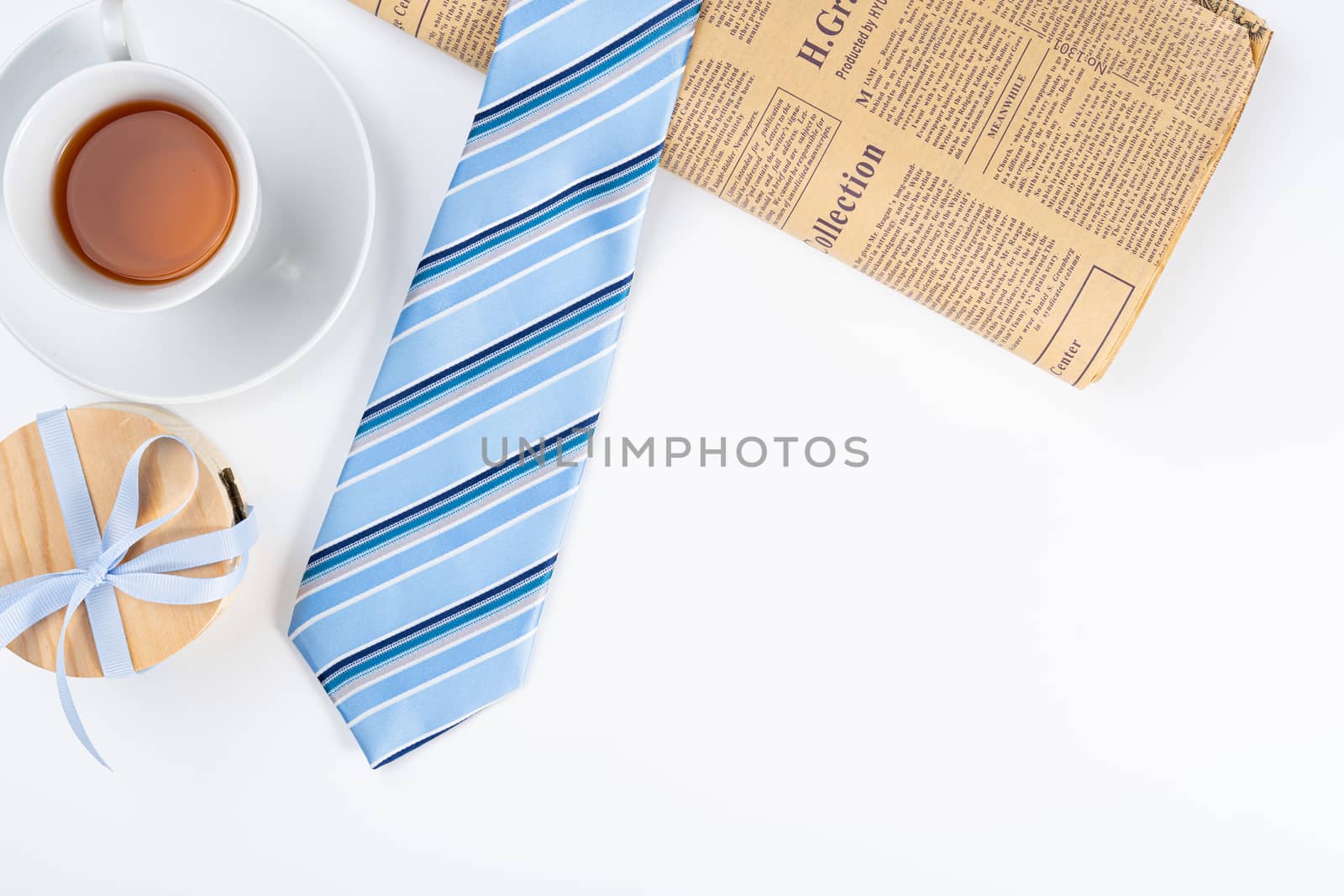 Happy Father Day background concept with blue necktie, cup of tea and gift box on white background with copy space for text.
