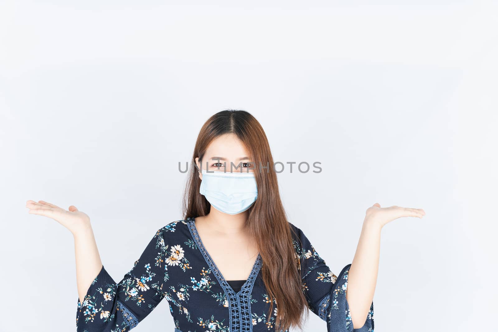 Asian beautiful happy hipster woman wearing a medical protection face mask for protect the coronavirus, filter dust PM 2.5 and cold and her hand carrying somthing over head on the white background