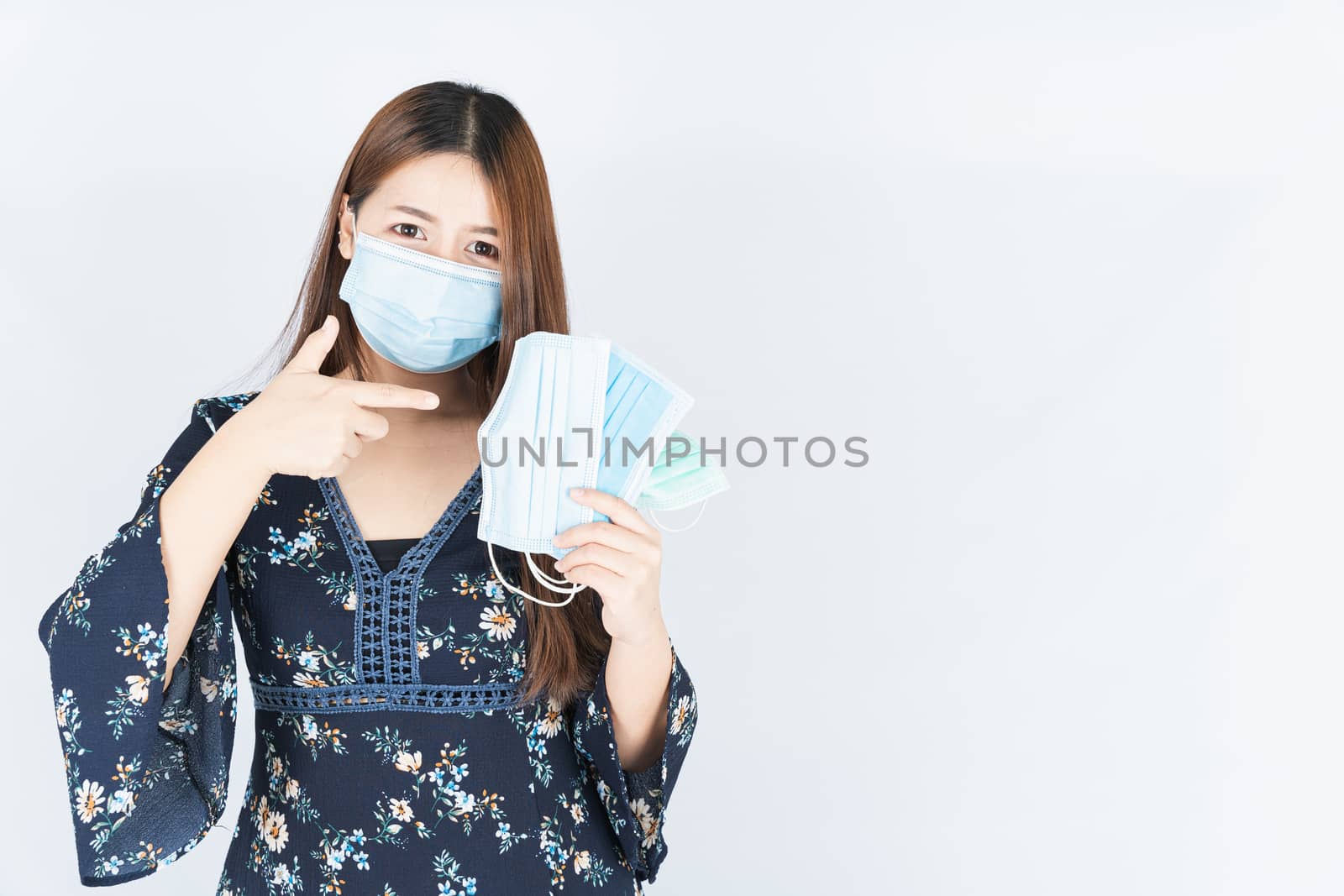 Asian beautiful happy hipster woman showing a medical protection by mikesaran