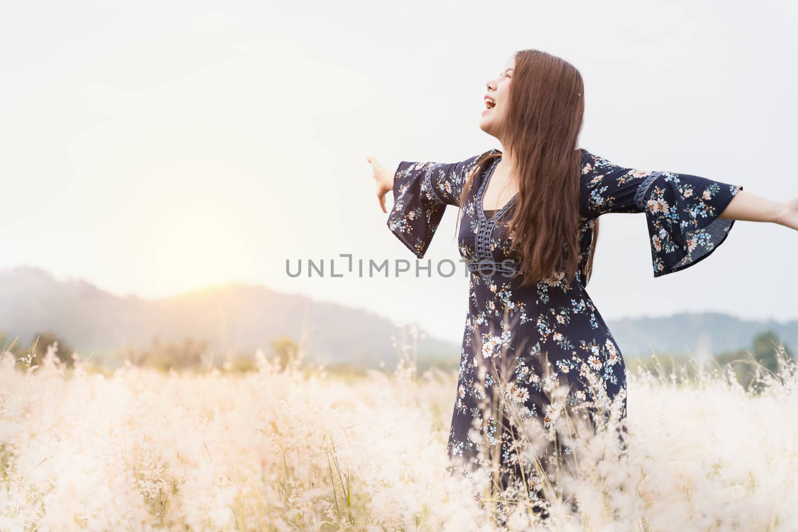 Summer portrait of young hipster woman standing in meadow on sun by mikesaran