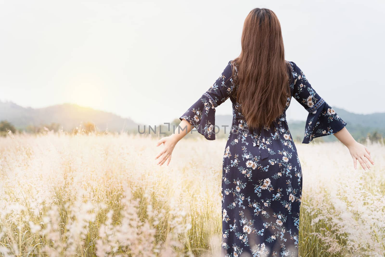 Summer portrait of young hipster woman standing in meadow on sunny day.young slim beautiful woman, bohemian outfit, indie style, summer vacation, sunny, having fun, positive mood, romantic, woman in hat