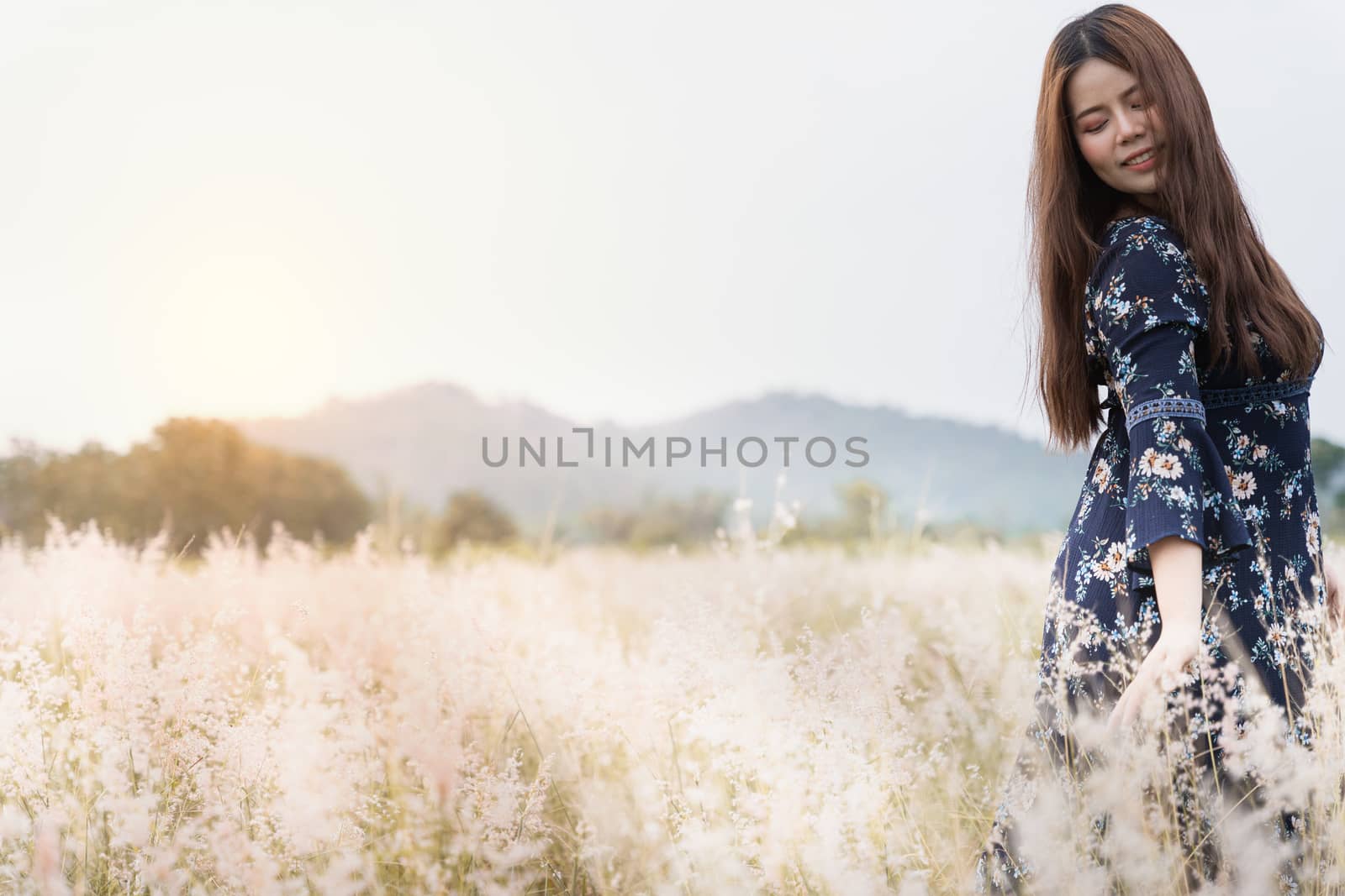 Summer portrait of young hipster woman standing in meadow on sun by mikesaran