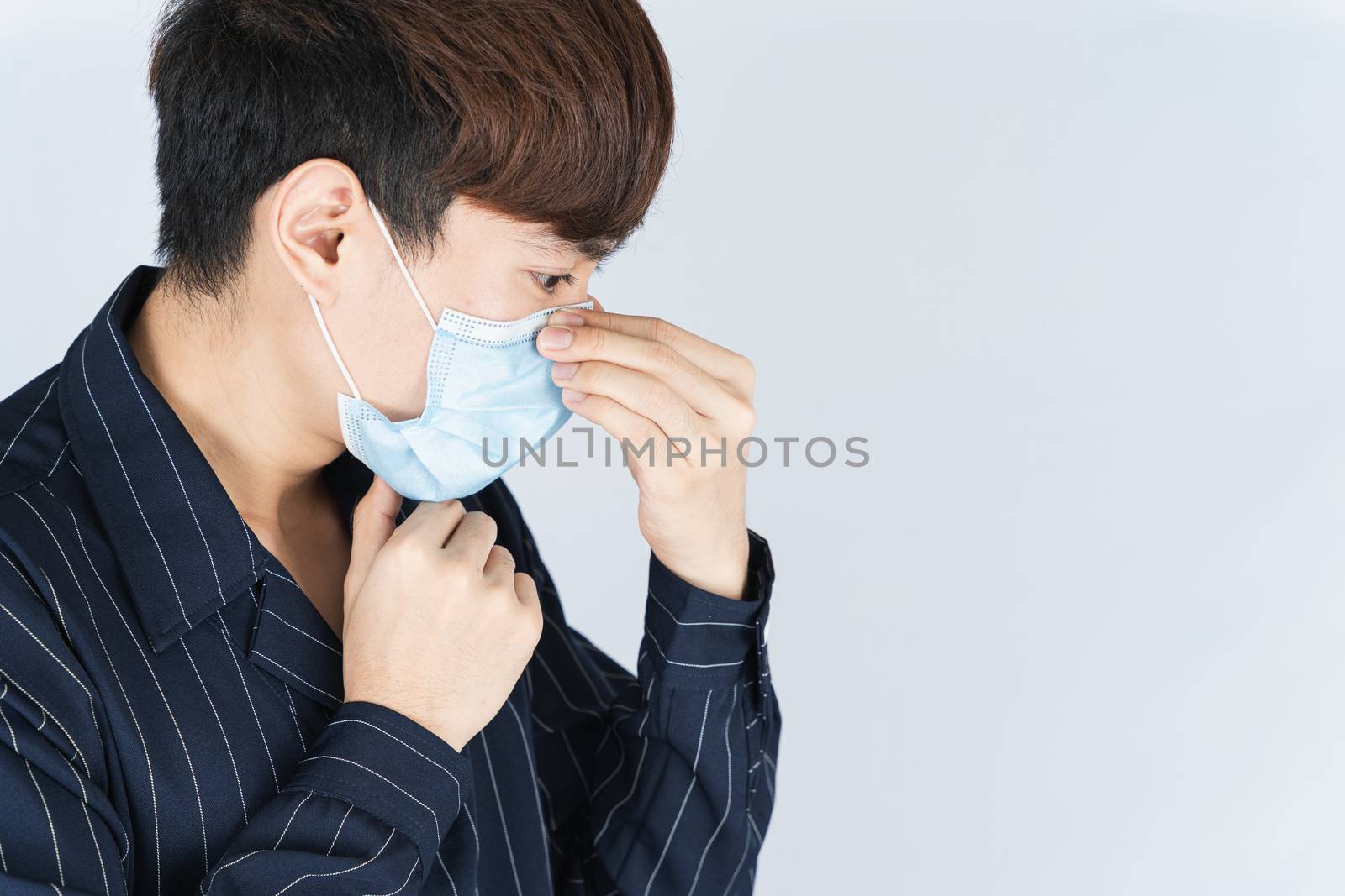 Asian handsome happy hipster man wearing a medical protection face mask for protect the coronavirus, filter dust PM 2.5 and cold on white background