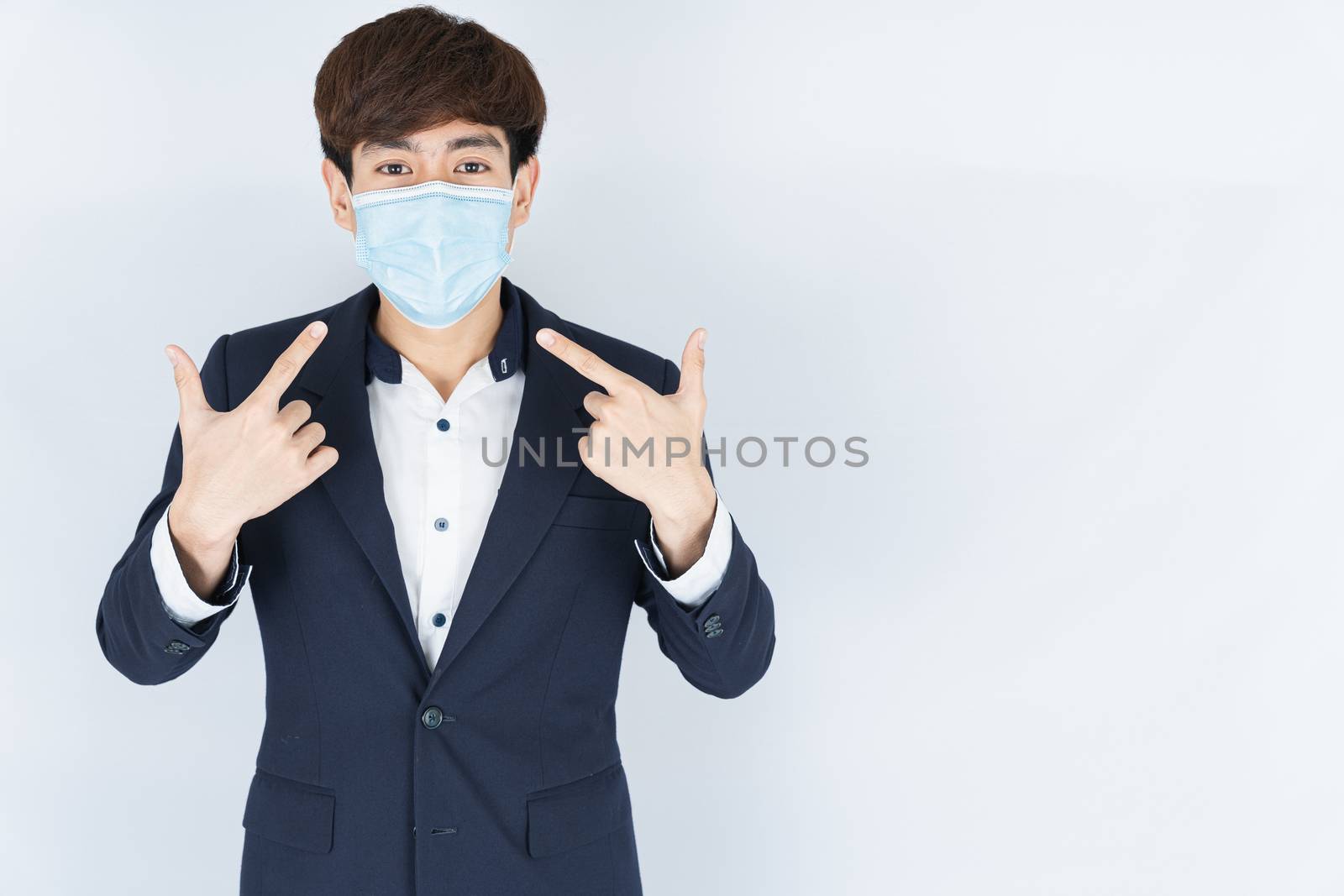 Asian handsome happy business man wearing a medical protection f by mikesaran