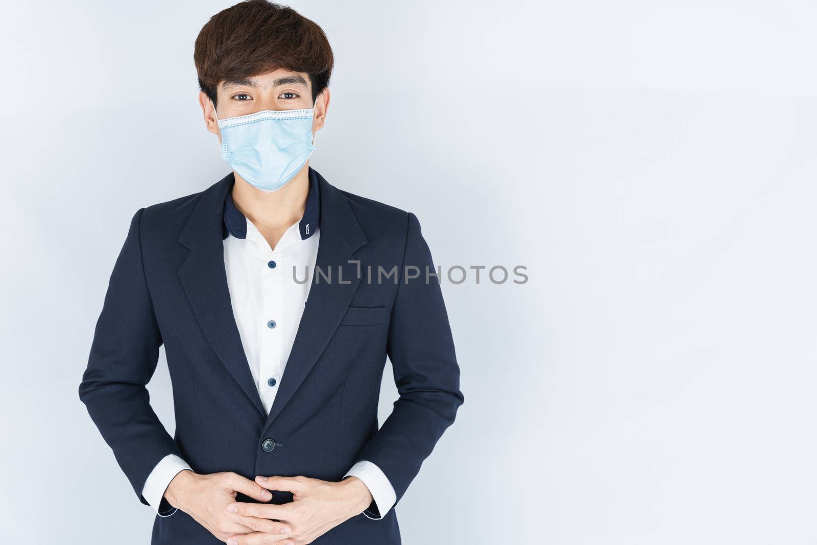 Asian handsome happy business man wearing a medical protection f by mikesaran