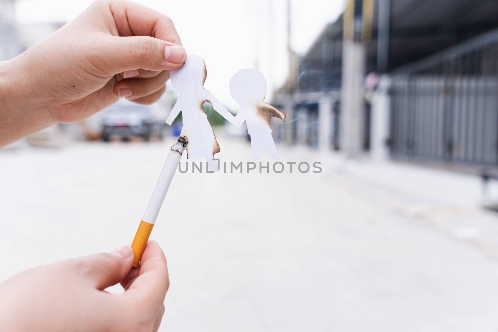 Paper cut of family members destroyed by cigarette. Smoking destroying family concept. Quit smoking for life on world tobacco day.