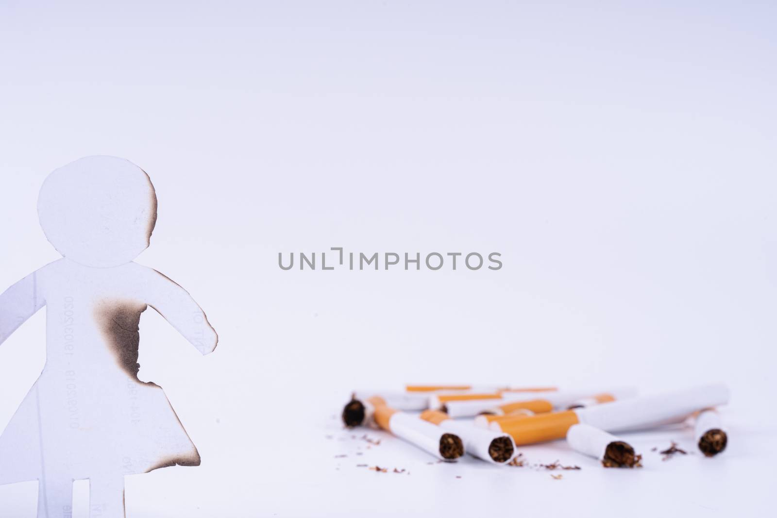 Paper cut of woman destroyed by cigarette. Smoking destroying li by mikesaran